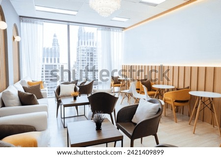 Empty stylish and modern office interior with skyscrapers view decorated with table, chair, botany decoration, elegant accessory. Living room. Modern interior. Creative design. Day light. Ornamented. Royalty-Free Stock Photo #2421409899