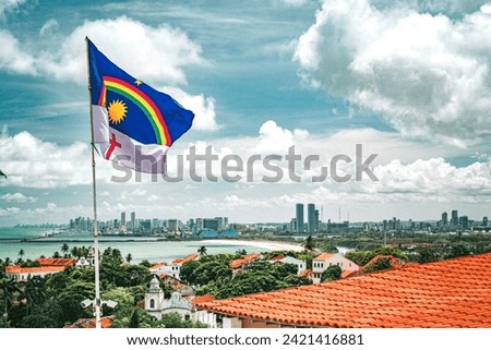 Recife, Pernambuco, Brazil. November, 19, 2016. The flag of Pernambuco waving at Alto da Sé. On the background, the cities of Olinda and Recife. Royalty-Free Stock Photo #2421416881