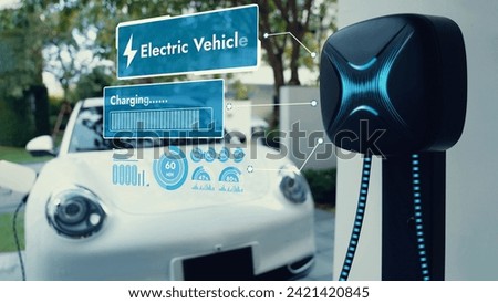 EV charger from home charging station plugged in and recharging electric car displaying digital battery status hologram. Smart and futuristic home energy infrastructure. Peruse