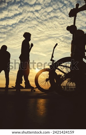 Skateboarding and BMX bike Silhouette Extreme Skatepark Images Orange Sunlight Youth Culture Enjoy Sports Vacation Skateboard