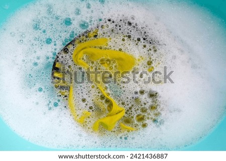 Men's underwear soaked in water dissolved detergent with white foam bubble. Laundry concept