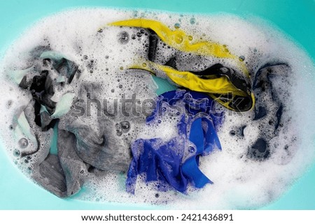 Men's underwear soaked in water dissolved detergent with white foam bubble. Laundry concept