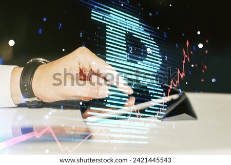 Double exposure of creative Bitcoin symbol hologram and hand working with a digital tablet on background. Mining and blockchain concept