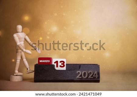 Calendar brilliance in March: Wooden character directs to the thirteenth day amidst a warm-toned, bright background.