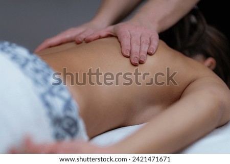Lomi Lomi Hawaiian back massage at a wellness center, embracing the rhythmic flow for ultimate relaxation