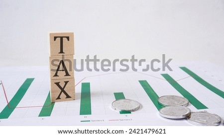 TAX word is made of wooden building blocks with economic graphic Business, economic concept, white background