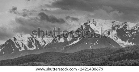 Black and white landscape, panorama. Snow-capped mountain peaks. Traveling in the mountains, climbing. 
