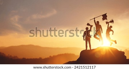 Success and achieving goals. Silhouette of businessman holding a trophy and flag on top of the mountain. concept of victory in competition Business and strategic planning for future business growth. Royalty-Free Stock Photo #2421512117