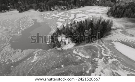 Flight over a freezing lake Iso-Kukkanen in Finland