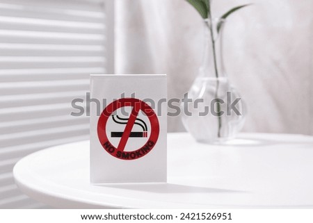 No Smoking sign on white table indoors, space for text