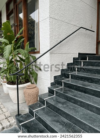 Circular railing gracing a staircase entrance: A seamless blend of elegance and functionality, it spirals gracefully, enhancing the entrance with architectural sophistication and aesthetic charm.