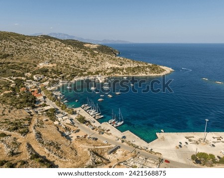 Aerial drone photo of Agios Nikolaos - a small port on the island of Zante.  Port on a Greek island with blue turquoise water with many boats and yachts on the water in Greece, Zakynthos.