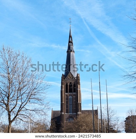 Catholic church spire with clock Royalty-Free Stock Photo #2421573485