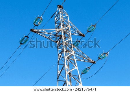 Pylon and high-voltage power line  Royalty-Free Stock Photo #2421576471