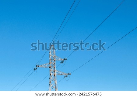 Pylon and high-voltage power line  Royalty-Free Stock Photo #2421576475