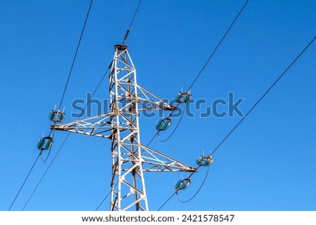 Pylon and high-voltage power line  Royalty-Free Stock Photo #2421578547