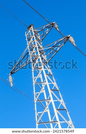 Pylon and high-voltage power line  Royalty-Free Stock Photo #2421578549