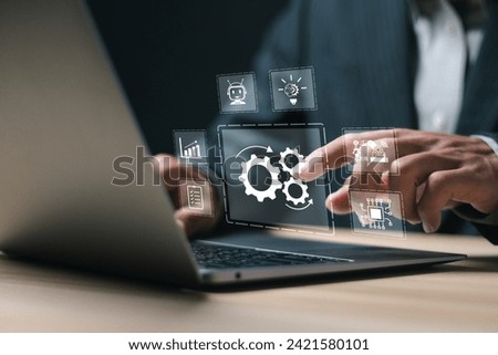 RPA, Robotic process automation concept. Businessman use laptop with virtual automation technology for automate business tasks with AI.  Digital transformation and change management. Royalty-Free Stock Photo #2421580101