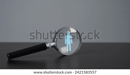 Symbol of a man in a magnifying glass. Finding people for work. Recruitment process, a search for workers to join a team or project. Quest for talent and unique qualities in candidates.