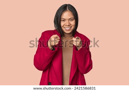 Young chinese woman isolated pointing to front with fingers.