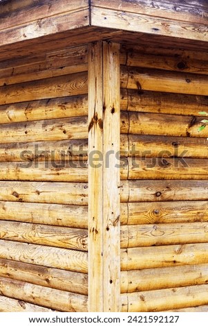corner of the house decorated with a blockhouse planks to simulate a log house Royalty-Free Stock Photo #2421592127