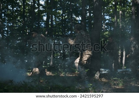A specialized military antiterrorist unit conducts a covert operation in dense, hazardous woodland, demonstrating precision, discipline, and strategic readiness Royalty-Free Stock Photo #2421595297
