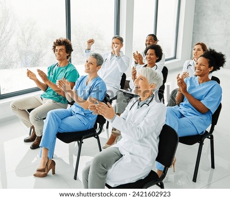 Portrait of a young doctors and nurses in audiance during a seminar in a board room or during an educational class at convention center  Royalty-Free Stock Photo #2421602923