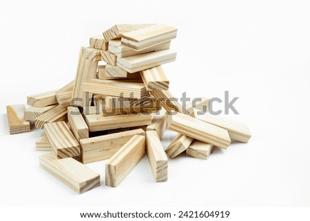 Closeup view of the tower of the wooden block falling on a white background. Jenga tower