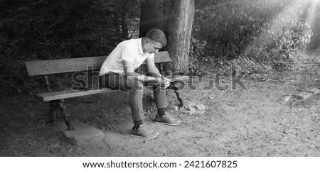 Young teen tired mental fail despair grief upset mood guilty boy feel hope look rural city town retro bush text space. Lost break love frown guy seat rest old retro vintage chair wait believe cry God Royalty-Free Stock Photo #2421607825