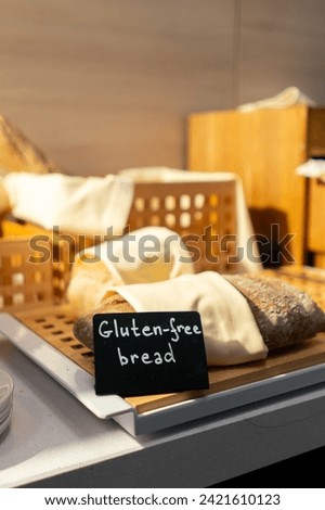 close-up breakfast buffet line serving pastries in hotel gluten-free bread with signs hospitality