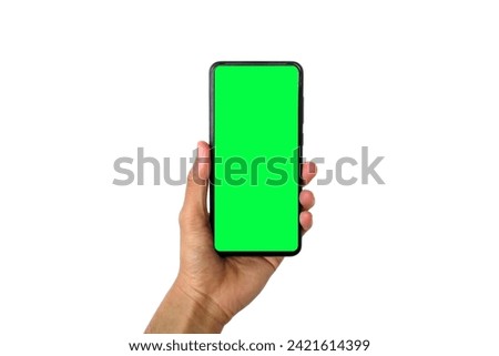 an Asian man's hand holding a mobile phone with a green screen isolated on a white background.