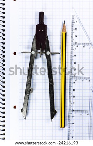 pencil, ruler and compass on notebook