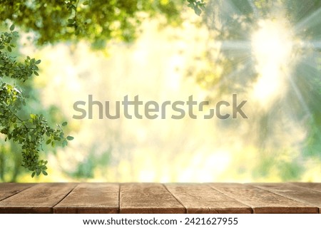Empty wooden table on nature outdoor for free space for product. Spring beautiful background