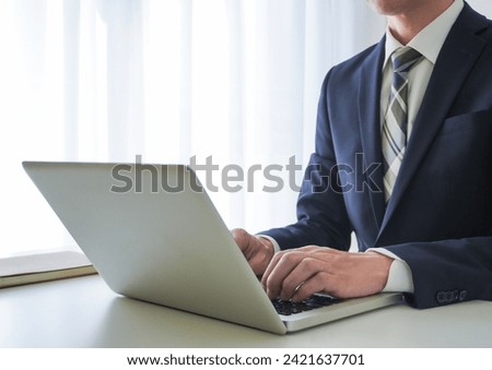 Image background of a businessman operating a laptop