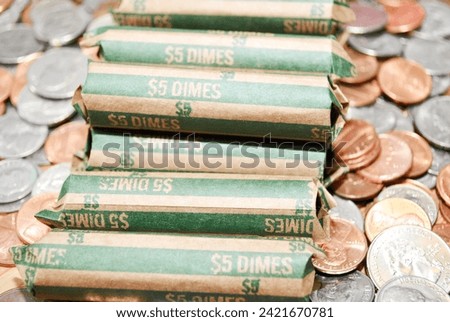 Rolled Bank Dimes on Mixed Coinage Royalty-Free Stock Photo #2421670781