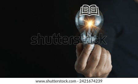 light bulb glowing on book, idea of ​​inspiration from reading, innovation idea concept, Self learning or education knowledge and business studying concept.