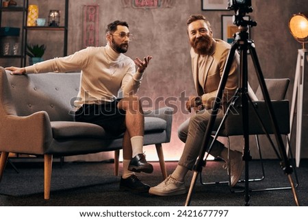 handsome men in fashionable clothing with accessories sitting and discussing interview questions