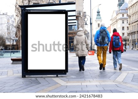 bus shelter with blank white ad billboard at busstop. urban street setting. glass structure. blank area for poster sign. lightbox. banner and copy space. selective focus. mockup base. soft background