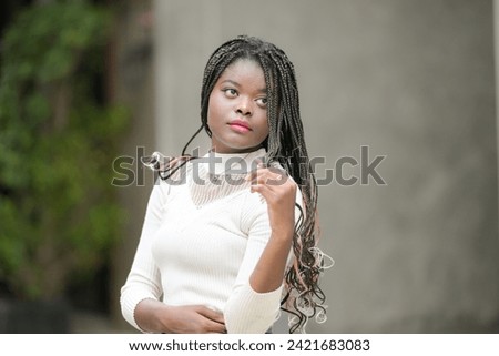 A young woman with his hairstyle and the atmosphere of living in the community.