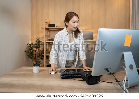 Happy female video editor works indoors in creative office studio. Royalty-Free Stock Photo #2421683529