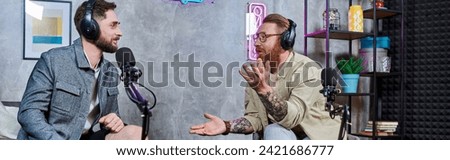 good looking interviewer and guest with headphones in studio discussing questions, podcast, banner