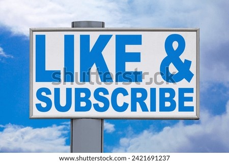 Close-up on a white billboard against a cloudy blue sky with the message "Like and Subscribe" written in the middle.