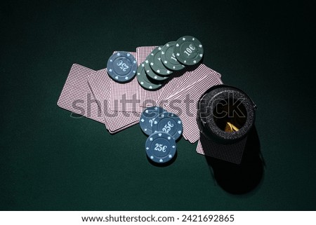 Poker chips, cards and pot with coins on dark green background. St. Patrick's Day celebration