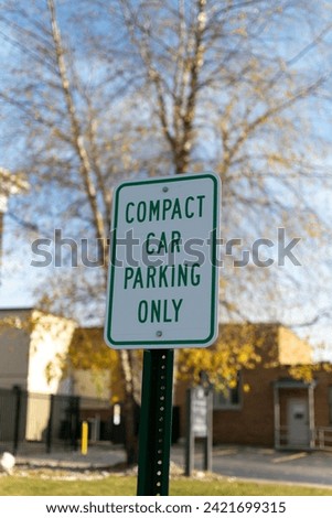 Compact car parking only sign outside a government building