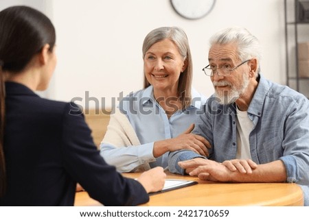 Notary consulting senior couple about Last Will and Testament in office Royalty-Free Stock Photo #2421710659