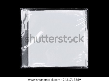 CD case on black background. Isolated transparent disk mockup. Clean cover box template. Royalty-Free Stock Photo #2421713869