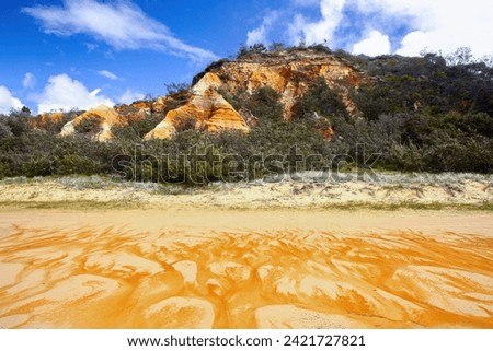 The Pinnacles are coloured sands cliffs located along the 75 mile beach on the east coast of Fraser Island, Queensland, Australia - They have been stained over thousands of years with clay Royalty-Free Stock Photo #2421727821