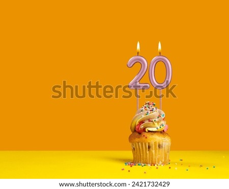 Lighted birthday candle - Celebration card with candle number 20 Royalty-Free Stock Photo #2421732429