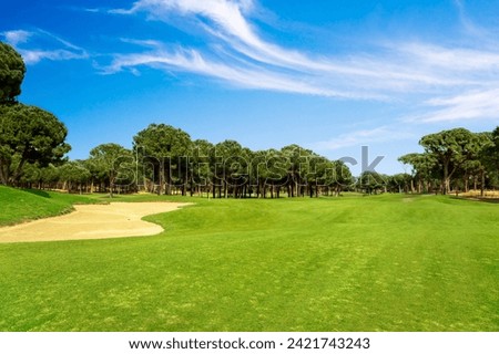 Scenic panoramic view of golf fairway at the golf course Royalty-Free Stock Photo #2421743243