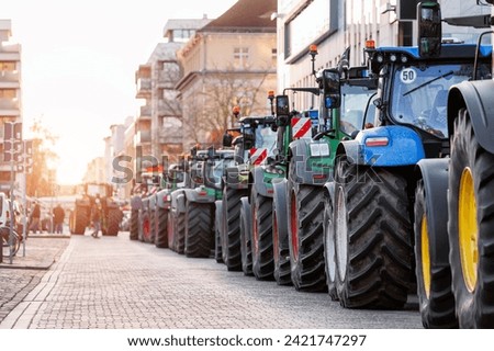 Farmers union protest strike against government Policy in Germany Europe. Tractors vehicles blocks city road traffic. Agriculture farm machines Magdeburg central Domplatz square Royalty-Free Stock Photo #2421747297